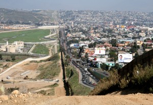 A small fence separates densely populated Tijuana, Mexico, right, from the United States in the Border Patrol?s San Diego Sector.  Construction is underway to extend a secondary fence over the top of this hill and eventually to the Pacific Ocean.