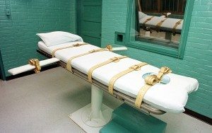 HUNTSVILLE, UNITED STATES:  This 29 February, 2000, photo shows the "death chamber" at the Texas Department of Criminal Justice Huntsville Unit in Huntsville, Texas, where convicted murderer Odell Barnes is scheduled to die by lethal injection 01 March. Barnes was convicted of the 1989 murder of his girlfriend. French President Jacques Chirac asked former US President George Bush 24 February to intervene and save Barnes' life, in light of new evidence discovered by lawyers in 1997 which they said showed Barnes was framed by police investigating the murder. A pardon for Barnes must come from Texas Gov. George W. Bush, son of the former president and Republican presidential hopeful. The executioners room is behind the glass window, and the injection is administered via tubes that pass through the opening (C) in the wall.  AFP PHOTO/Paul BUCK (Photo credit should read PAUL BUCK/AFP/Getty Images)